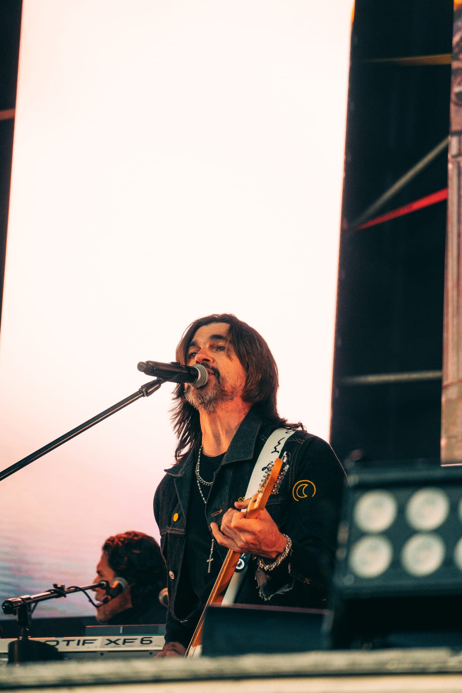 Juanes frente al micrófono con su guitarra
